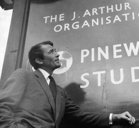 Der amerikanische Schauspieler Gregory Peck vor dem Eingangsschild der Pinewood Studios, westlich von London, ca. 1956. American actor Gregory Peck in front of the entrance sign of Pinewood Studios, near London, ca. 1956. Copyright: Roba RobaxArchiv UnitedArchives00655