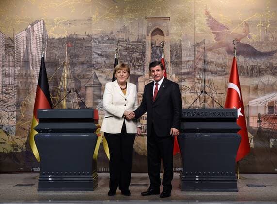 (151018) -- ISTANBUL, Oct. 18, 2015 -- German Chancellor Angela Merkel(L) shake hands with Turkish Prime Minister Ahmet Davutoglu at a joint press conference in Istanbul, Turkey, on Oct 18, 2015. Turkish Prime Minister Ahmet Davutoglu on Sunday voiced readiness to work with Germany to prevent illegal migration to Europe, calling for a resolution to the Syrian conflict to stem the crisis. ) TURKEY-ISTANBUL-GERMANY-MERKEL-SYRIAN REFUGEE CRISIS HexCanling 