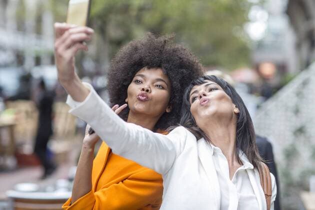 Two friends posing for a selfie model released Symbolfoto property released  ZEF007045