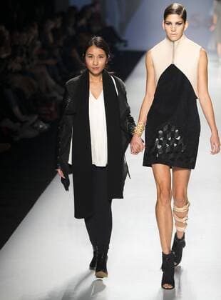 Feyanki Law (L) from Chinese Hong Kong and a model wearing her creations walk the runway during the the World MasterCard Toronto Fashion Week Spring Summer 2016 presenting the works by excellent students in Fashion Arts from Seneca College, in Toronto, Canada, Oct. 23, 2015. ) CANADA-TORONTO-FASHION WEEK-CHINESE STUDENTS ZouxZheng 