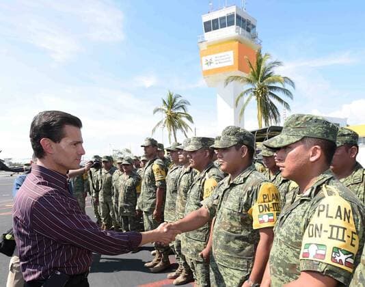 Image provided by Mexico s Presidency shows Mexican President Enrique Pena Nieto (L) greeting soldiers during his visit to the municipality affected by the passage of hurricanne Patricia of Armeria, Colima state, Mexico, on Oct. 24, 2015. According to a statement, Pena Nieto informed that there are no considerable damages as local people followed the alerts and recommendations of the authorities of Civil Protection, and that they spread the alert of the hurricane in time. Mexico s Presidency) (da) (fnc) MEXICO-COLIMA-POLITICS-PENA NIETO e MEXICO SxPRESIDENCY 