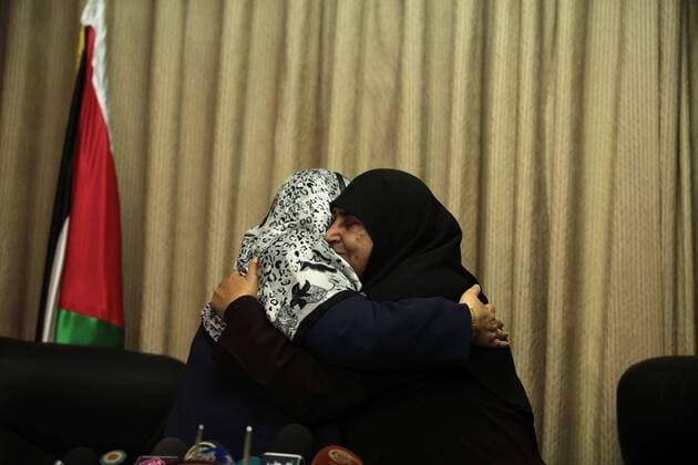 June 8, 2014 - Gaza City, Gaza Strip, Palestinian Territory - Former Palestinian Minister of Women s Affairs, Jamila al-Shanti meets with new minister of woman s Affairs in the Palestinian unity government, Haifa Al-Agha, to hand over the ministry s duties, in Gaza City on June 08, 2014. A long-awaited government of national unity headed by Prime Minister Rami Hamdallah was sworn in by President Mahmoud Abbas in the West Bank in Ramallah city For the first time in seven years, the Palestinians have one government in charge of both the West Bank and the Gaza Strip - ZUMAap3