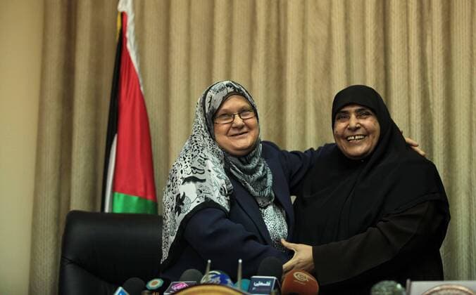 June 8, 2014 - Gaza City, Gaza Strip, Palestinian Territory - Former Palestinian Minister of Women s Affairs, Jamila al-Shanti meets with new minister of woman s Affairs in the Palestinian unity government, Haifa Al-Agha, to hand over the ministry s duties, in Gaza City on June 08, 2014. A long-awaited government of national unity headed by Prime Minister Rami Hamdallah was sworn in by President Mahmoud Abbas in the West Bank in Ramallah city For the first time in seven years, the Palestinians have one government in charge of both the West Bank and the Gaza Strip - ZUMAap3