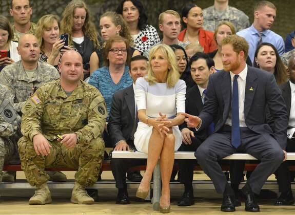 HRH Prince Harry (R) and Dr. Jill Biden sit on the sidelines as they watch a basketball game by wounded service members, October 28, 2015, at Ft. Belvoir, Virginia. The event is a celebration of the Joining Forces Initiative and the upcoming 2016 Invictus Games in Orlando, Florida, in which wounded military personnel compete in sporting competition.  WAP20151028507 MIKExTHEILER
