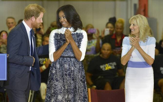 HRH Prince Harry (L) is applauded by First Lady Michelle Obama (C) and Dr. Jill Biden after remarks and before the start of a basketball game by wounded service members, October 28, 2015, at Ft. Belvoir, Virginia. The event is a celebration of the Joining Forces Initiative and the upcoming 2016 Invictus Games in Orlando, Florida, in which wounded military personnel compete in sporting competition.  WAP20151028514 MIKExTHEILER
