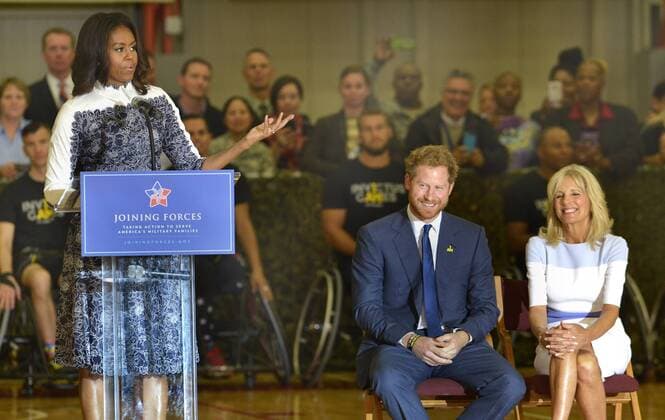 First Lady Michelle Obama (L) makes remarks as HRH Prince Harry and Dr. Jill Biden listen prior to a basketball game by wounded service members, October 28, 2015, at Ft. Belvoir, Virginia. The event is a celebration of the Joining Forces Initiative and the upcoming 2016 Invictus Games in Orlando, Florida, in which wounded military personnel compete in sporting competition.  WAP20151028515 MIKExTHEILER