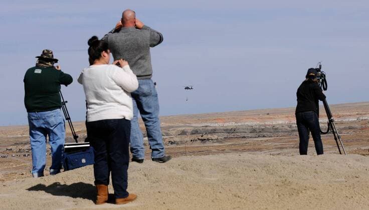 Oct. 29, 2015 - Albuquerque, NM, U.S. - People watch as a New Mexico National Guard Black Hawk Helicopter retrieves the first baby Pentaceratops from the Bisti Wilderness Area in the Four Corners region of New Mexico. Thursday, Oct. 29, 2015. Albuquerque U.S. - ZUMAab1_