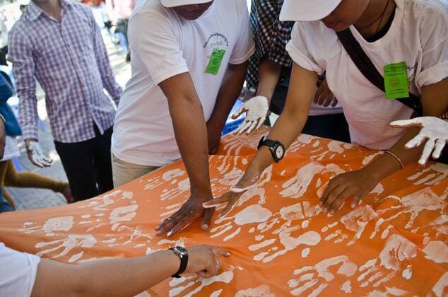 Nov. 9, 2014 - Phnom Penh, Cambodia - Human rights demonstrators make a bannered petition of hand prints to free jailed activists. Human rights day, Freedom park, Phnom Penh, Cambodia.  - ZUMAn23