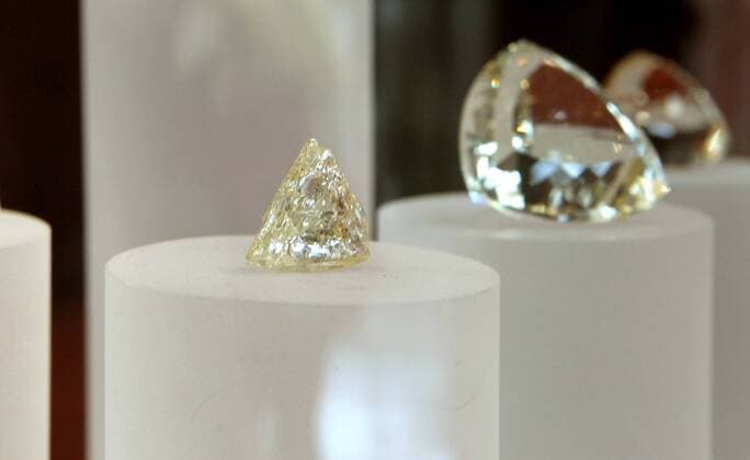 Dec. 30, 2014 - San Diego, California, United States - December 30, 2014_Carlsbad, California_USA_ Detail view of a rough uncut diamond, at left, on display with gems in the lobby of the Gemological Institute of America in Carlsbad. _Mandatory Photo - ZUMAs44