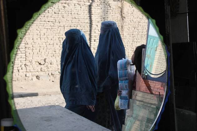 Oct. 28, 2014 - Kabul, Afghanistan - burqa-clad Afghan women are reflected on mirrors as they walk in a street market in kabul,Afghanistan on October 28, 2014.  - ZUMAn23
