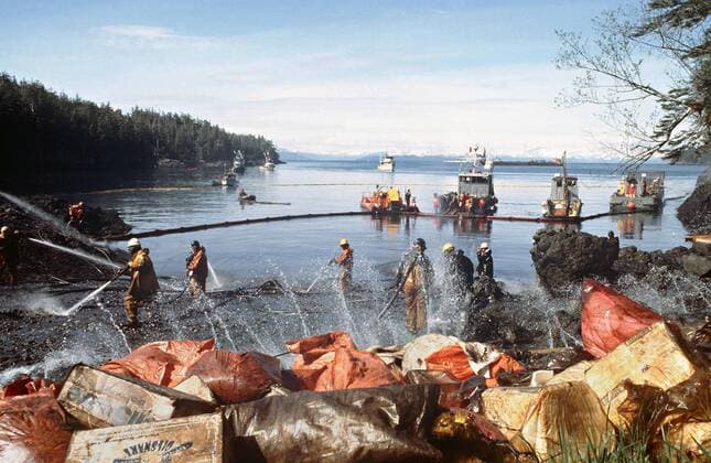 March 28, 1989 - Prince William Sound, AK, United States of America - Workers steam blast rocks and wash down the shoreline soaked in crude oil from the leaking tanker Exxon Valdez after running aground on Bligh Reef in Prince William Sound spilling at least 11 million gallons of crude oil in the pristine waters March 28, 1989 in Prince William Sound, Alaska. Prince William Sound United States of America - ZUMAp138