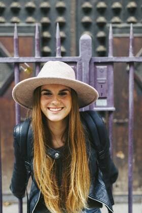 Spain, Barcelona, smiling young woman in front of entrance portal  EBSF000936