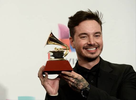 Ay Vamos poses in the pressroom with the Best Urban Song Award during the 16th Annual Latin Grammy Awards at the MGM Grand Garden Arena in Las Vegas, Nevada on November 19, 2015.  LAV20151119605 JIMxRUYMEN