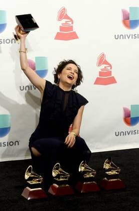 Natalia Lafourcade poses in the press room with the awards for best alternative music album, best alternative song, record of the year, song of the year and best engineered album for Hasta La Raiz during the 16th Annual Latin Grammy Awards at the MGM Grand Garden Arena in Las Vegas, Nevada on November 19, 2015.  LAV20151119619 JIMxRUYMEN
