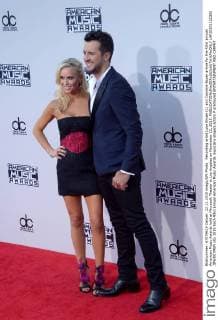 Recording artist Luke Bryan (L) and Caroline Boyer arrive for the 43rd annual American Music Awards held at Microsoft Theater in Los Angeles on November 22, 2015.  LAP20151122302 JIMxRUYMEN