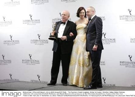 The Founders Award recipient, Writer & Creator, Downton Abbey Julian Fellowes celebrates with presenters Elizabeth McGovern and Gareth Neame in the pressroom at the 43rd International Emmy Awards at the New York Hilton in New York City on November 23, 2015.  NYP20151123176 JOHNxANGELILLO