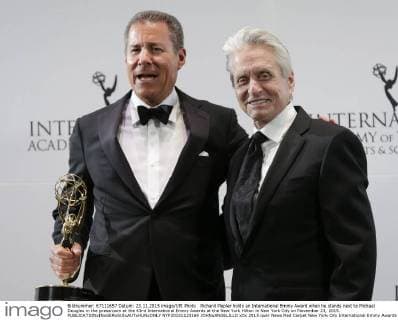 Richard Plepler holds an International Emmy Award when he stands next to Michael Douglas in the pressroom at the 43rd International Emmy Awards at the New York Hilton in New York City on November 23, 2015.  NYP20151123169 JOHNxANGELILLO