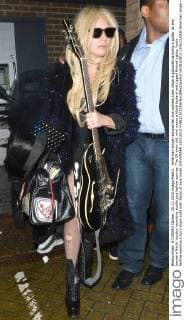 American singer-songwriter and actress Lady Gaga is pictured carrying a guitar as she leaves a North London recording studio just before sunrise. The 29-year-old, who wears a black leotard and ripped fishnet tights, looks festive wearing a furry black coat with flecks of blue tinsel. NOVEMBER 25th 2015  LTNx153506