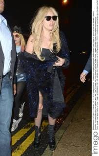 American singer-songwriter and actress Lady Gaga is pictured as she leaves a North London recording studio just before sunrise. The 29-year-old, who wears a black leotard and ripped fishnet tights, looks festive wearing a furry black coat with flecks of blue tinsel. NOVEMBER 25th 2015  LTNx153506