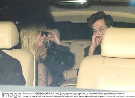 American singer-songwriter and actress Lady Gaga is pictured as she leaves a North London recording studio just before sunrise, where she gets into a car with English musician and record producer Mark Ronson. The 29-year-old, who wears a black leotard and ripped fishnet tights, looks festive wearing a furry black coat with flecks of blue tinsel. NOVEMBER 25th 2015  LTNx153506