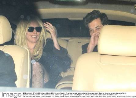 American singer-songwriter and actress Lady Gaga is pictured as she leaves a North London recording studio just before sunrise, where she gets into a car with English musician and record producer Mark Ronson. The 29-year-old, who wears a black leotard and ripped fishnet tights, looks festive wearing a furry black coat with flecks of blue tinsel. NOVEMBER 25th 2015  LTNx153506