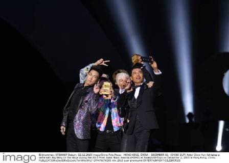 HONG KONG, CHINA - DECEMBER 02: (CHINA OUT) Actor Chow Yun-fat takes a selfie with Big Bang on the stage during the 2015 Mnet Asian Music Awards (MAMA) at AsiaWorld-Expo on December 2, 2015 in Hong Kong, China.  CFP476670395