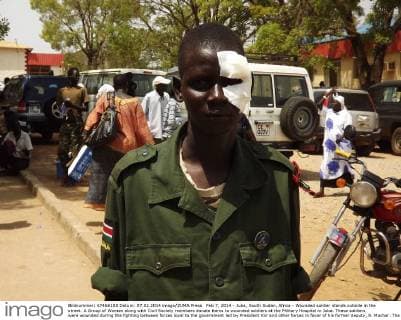 Feb 7, 2014 - Juba, South Sudan, Africa - Wounded soldier stands outside in the street. A Group of Women along with Civil Society members donate items to wounded soldiers at the Military Hospital in Juba. These soldiers were wounded during the fighting between forces loyal to the government led by President Kiir and other forces in favor of his former deputy, R. Machar. The conflict began December 15, 2103 which has killed more than a thousand people and displaced families.  - ZUMAb13