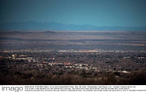 Dec. 10, 2015 - Albuquerque, New Mexico, U.S. - Journal.A missile launch over N.M. is seen in the distance from the foothills early morning. The missile test which was launched from Fort Wingate left a white contrail that quickly turned into a corkscrew that was visible for hundreds of miles. The unarmed Juno target missile was launched at 6:55 a.m. mountain standard time. Mount Taylor near Grants, New Mexico is seen in the background just below the missile traveling above the horizon...Albuquerque, New Mexico Albuquerque U.S. - ZUMAab1_