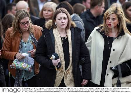Dec. 10, 2015 - Toronto, ON, Canada - TORONTO, ON - DECEMBER 10 - Nicole Wellwood carry s a stuffed toy after the interment of her seven-year-old son Evan Leversage, at St. George Cemetery in St. George, Ontario, December 10, 2015. Evan, who battled brain cancer for most of his young life, made headlines internationally when homes and businesses in the Ontario town put their Christmas decorations up in October, after doctors told his family he was unlikely to live to Christmas and they should celebrate early. Toronto Canada - ZUMAt14_