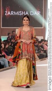 (151211) -- LAHORE, Dec. 11, 2015 -- A model presents a creation by Pakistani designer Zarmisha Dar on the first day of the Fashion Bridal Couture Week in eastern Pakistan s Lahore on Dec. 11, 2015. ) PAKISTAN-LAHORE-BRIDAL COUTURE WEEK JamilxAhmed 