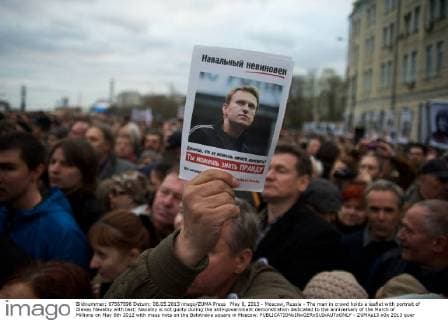 May 6, 2013 - Moscow, Russia - The man in crowd holds a leaflet with portrait of Alexey Navalny with text: Navalny is not guilty during the anti-government demonstration dedicated to the anniversary of the March of Millions on May 6th 2012 with mass riots on the Bolotnaya square in Moscow. - ZUMAs13
