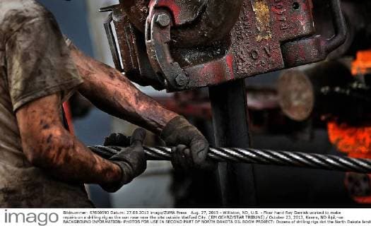 Aug. 27, 2013 - Williston, ND, U.S. - Floor hand Ray Gerrish worked to make repairs on a drilling rig as the sun rose near the site outside Watford City. (JIM GEHRZ STAR TRIBUNE) October 23, 2013, Keene, ND Ã¢â‚¬œ BACKGROUND INFORMATION- PHOTOS FOR USE IN SECOND PART OF NORTH DAKOTA OIL BOOM PROJECT: Dozens of drilling rigs dot the North Dakota landscape in the Williston Basin and the Bakken Oil Formation. Once the rigs drill holes, several miles deep and then several miles horizontally, hydraulic fracturing technology (Ã¢â‚¬Å frackingÃ¢â‚¬) is then employed to extract oil and natural gas from the underlying shale formation. Workers at this rig, Raven Drilling Rig 1, located near Watford City, toil around the clock to drill holes along a prescribed route. - ZUMAm42
