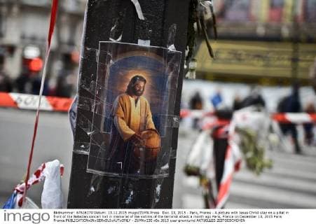 Dec. 13, 2015 - Paris, France - A picture with Jesus Christ stay on a pillat in front of the Bataclan concert hall in memorial of the victims of the terrorist attack a month ago Paris, France on December 13, 2015 Paris France  - ZUMAn230