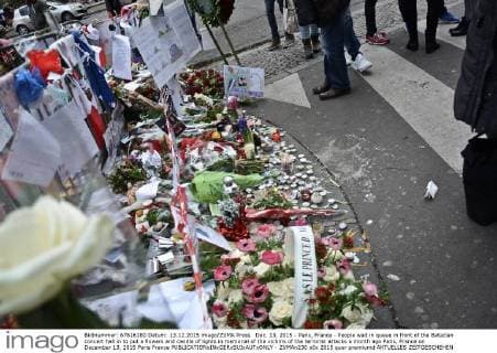 Dec. 13, 2015 - Paris, France - People wait in queue in front of the Bataclan concert hall in to put a flowers and candle of lights in memorial of the victims of the terrorist attacks a month ago Paris, France on December 13, 2015 Paris France  - ZUMAn230