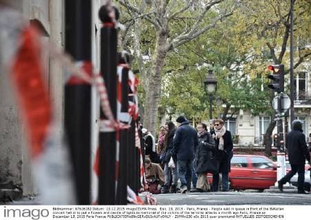 Dec. 13, 2015 - Paris, France - People wait in queue in front of the Bataclan concert hall in to put a flowers and candle of lights in memorial of the victims of the terrorist attacks a month ago Paris, France on December 13, 2015 Paris France  - ZUMAn230