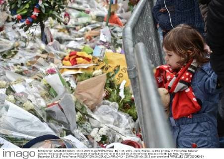 Dec. 13, 2015 - Paris, France - A little girl stay in front of the Bataclan concert hall in to put a flowers and candle of lights in memorial of the victims of the terrorist attacks a month ago Paris, France on December 13, 2015 Paris France  - ZUMAn230