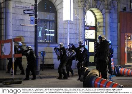 (151219) -- MONTREAL, Dec. 19, 2015 -- Police clash with demonstrators during a demonstration in Montreal, Canada, on Dec. 19, 2015. Some 150 demonstrators took to street in Montreal Friday night in protest of austerity measures and capitalist system. Two demonstrators were arrested by the police and another two demonstrators were wounded during the demonstration. ) CANADA-MONTREAL-DEMONSTRATION KadrixMohamed 