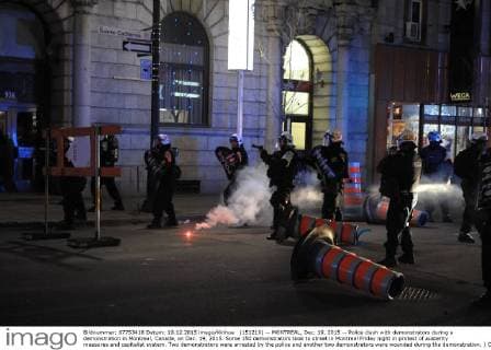 (151219) -- MONTREAL, Dec. 19, 2015 -- Police clash with demonstrators during a demonstration in Montreal, Canada, on Dec. 19, 2015. Some 150 demonstrators took to street in Montreal Friday night in protest of austerity measures and capitalist system. Two demonstrators were arrested by the police and another two demonstrators were wounded during the demonstration. ) CANADA-MONTREAL-DEMONSTRATION KadrixMohamed 