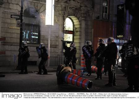 (151219) -- MONTREAL, Dec. 19, 2015 -- Police clash with demonstrators during a demonstration in Montreal, Canada, on Dec. 19, 2015. Some 150 demonstrators took to street in Montreal Friday night in protest of austerity measures and capitalist system. Two demonstrators were arrested by the police and another two demonstrators were wounded during the demonstration. ) CANADA-MONTREAL-DEMONSTRATION KadrixMohamed 