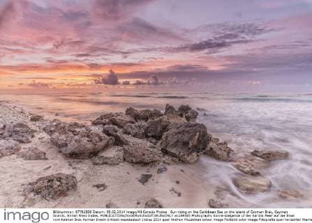 Sun rising on the Caribbean Sea on the island of Cayman Brac, Cayman Islands, British West Indies.  acp89385 Photography