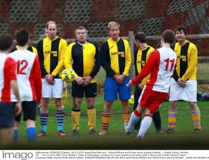 Prince William and Prince Harry playing football . . Castle Rising, Norfolk, UK . . 24.12.2015 HRH Prince William, Duke of Cambridge, protects his crown jewels as he takes part in an annual charity football match involving estate workers from Sandringham. 