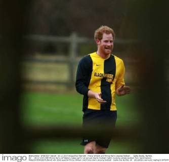 Prince William and Prince Harry playing football . . Castle Rising, Norfolk, UK . . 24.12.2015 HRH Prince Harry (of Wales), takes part in an annual charity football match involving estate workers from Sandringham. 
