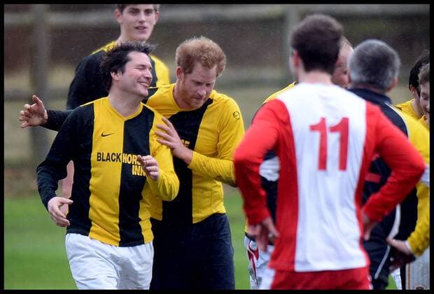 . 24 12 2015. Castle Rising, United Kingdom. Prince William and Prince Harry playing football on Christmas Eve in Castle Rising, Norfolk. Prince Harry celebrates with another team player as his team score  xAndrewxParsonsx xi-Imagesx IIM-11620-0062