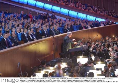 MOSCOW, RUSSIA. DECEMBER 25, 2015. Artistic director of Mariinsky Theatre Valery Gergiyev (C) conducts the orchestra at a concert by the Children s Choir of Russia in the State Kremlin Palace. Left: Russia s president Vladimir Putin. Alexei Druzhinin Russian Presidential Press and Information Office TASS  TS014A50