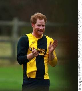 Prince William and Prince Harry playing football . . Castle Rising, Norfolk, UK . . 24.12.2015 HRH Prince Harry (of Wales), takes part in an annual charity football match involving estate workers from Sandringham. 