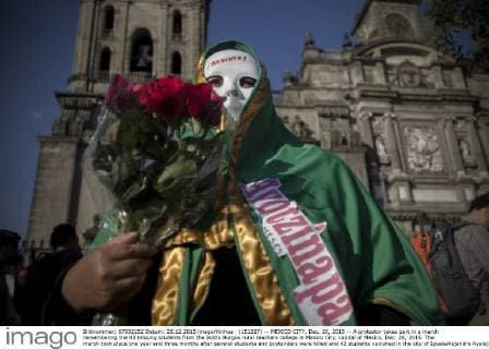 (151227) -- MEXICO CITY, Dec. 26, 2015 -- A protestor takes part in a march remembering the 43 missing students from the Isidro Burgos rural teachers college in Mexico City, capital of Mexico, Dec. 26, 2015. The march took place one year and three months after several students and bystanders were killed and 43 students vanished in the city of IgualaAlejandro Ayala) MEXICO-MEXICO CITY-MISSING STUDENTS-MARCH e AlejandroxAyala 