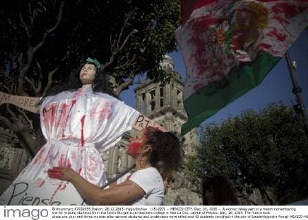 (151227) -- MEXICO CITY, Dec. 26, 2015 -- A woman takes part in a march remembering the 43 missing students from the Isidro Burgos rural teachers college in Mexico City, capital of Mexico, Dec. 26, 2015. The march took place one year and three months after several students and bystanders were killed and 43 students vanished in the city of IgualaAlejandro Ayala) MEXICO-MEXICO CITY-MISSING STUDENTS-MARCH e AlejandroxAyala 