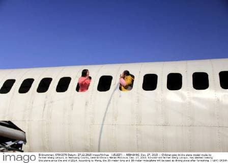 (151227) -- NEIHUANG, Dec. 27, 2015 -- Children play in the plane model made by farmer Wang Lanqun, in Neihuang County, central China s Henan Province, Dec. 27, 2015. 61-year-old farmer Wang Lanqun, has started making this plane since the end of 2014. According to Wang, the 35-meter-long and 38-meter-wide plane will be used as dining place after furnishing. ) (dhf) CHINA-HENAN-FARMER-PLANE MODEL (CN) LiuxXiaokun 