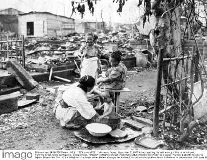 Yokohama, Japan: November 7, 1923 A baby getting his bath amongst the ruins left over from the Great Kanto Earthquake. in September. xUnderwoodxArchives 9-Japan-Women_1