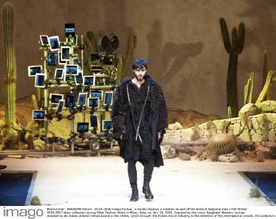 A model displays a creation as part of the Dolce & Gabbana men s Fall-Winter 2016-2017 show collection during Milan Fashion Week in Milan, Italy, on Jan. 16, 2016. Inspired by the iconic Spaghetti Western movies directed by an Italian director Sergio Leone in the 1960s, which brought the Italian movie industry to the attention of the international crowds, the collection shows a contrast between the past (via the embroideries and embellishments of the Wild West) and the present (the shapes, cut, and fit). ) ITALY-MILAN-D&G-FASHION WEEK JinxYu 